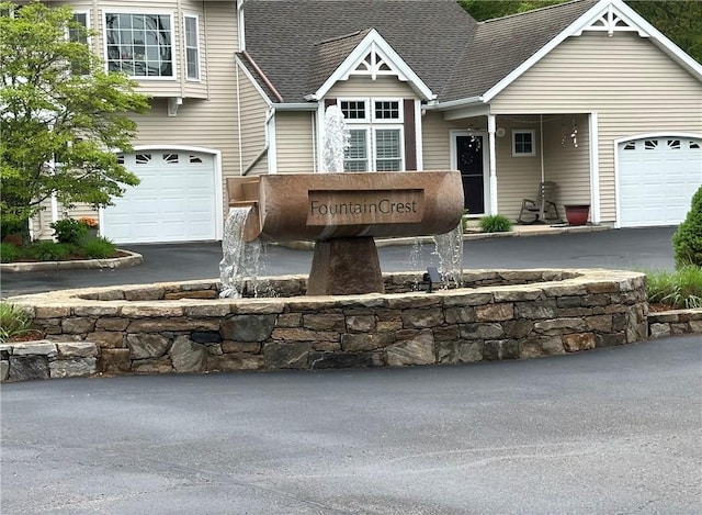 19 Calabria Ct Unit 19, Westerly, RI 02891 - view of exterior entry featuring roof with shingles and driveway