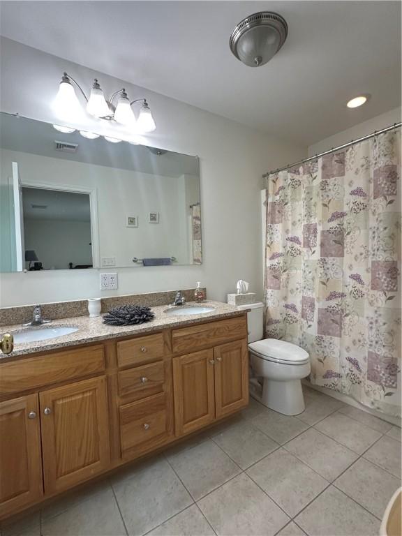 19 Calabria Ct Unit 19, Westerly, RI 02891 - full bathroom with tile patterned flooring, double vanity, toilet, and curtained shower