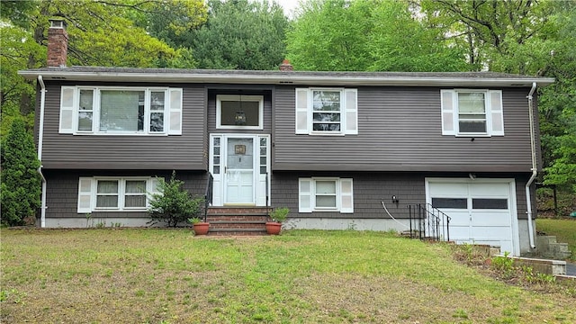 22 Winsor Ave, Johnston, RI 02919 - raised ranch featuring a chimney, a garage, entry steps, and a front yard
