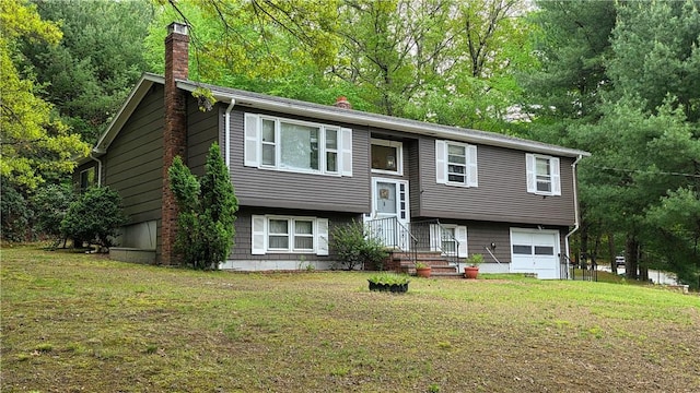 22 Winsor Ave, Johnston, RI 02919 - raised ranch featuring a chimney, an attached garage, and a front yard