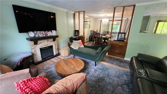 22 Winsor Ave, Johnston, RI 02919 - living area featuring wood finished floors, a stone fireplace, crown molding, and a chandelier