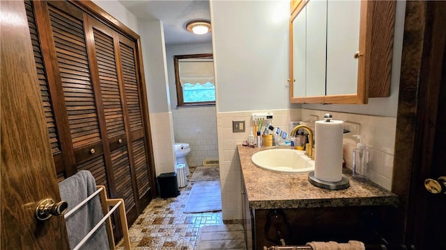 22 Winsor Ave, Johnston, RI 02919 - bathroom with toilet, vanity, wainscoting, a closet, and tile walls