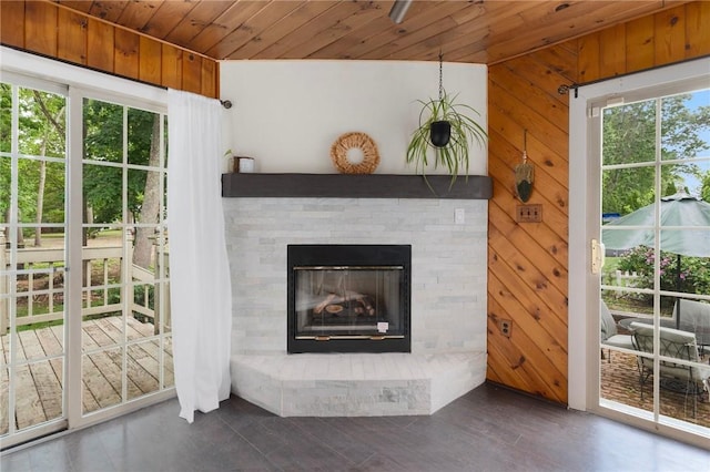 37 Charles St, Barrington, RI 02806 - unfurnished living room with wood ceiling, wooden walls, a glass covered fireplace, and wood finished floors