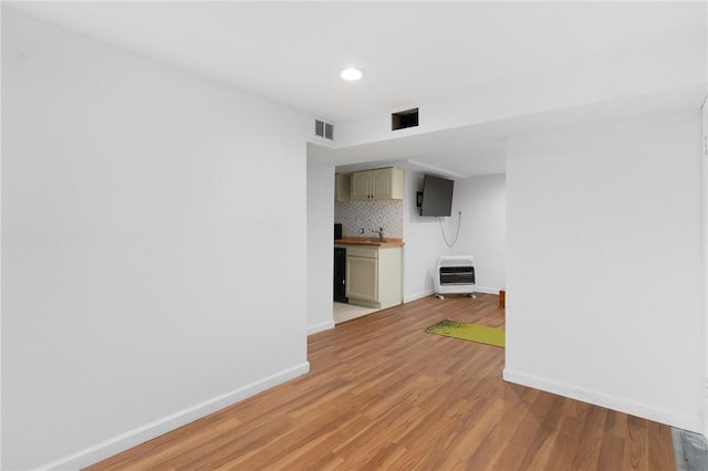 37 Charles St, Barrington, RI 02806 - unfurnished room with heating unit, baseboards, light wood-style floors, recessed lighting, and bar