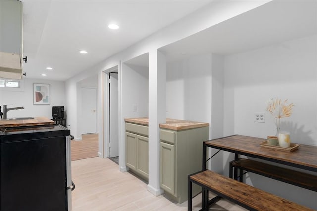 37 Charles St, Barrington, RI 02806 - kitchen with stove, light wood finished floors, recessed lighting, butcher block counters, and a sink