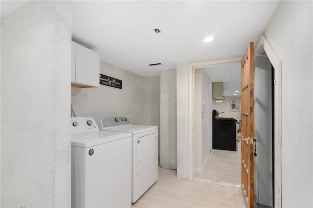 37 Charles St, Barrington, RI 02806 - laundry area with independent washer and dryer, cabinet space, light wood-style floors, and recessed lighting