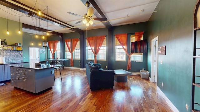 office area featuring wood finished floors, ceiling fan, and baseboards