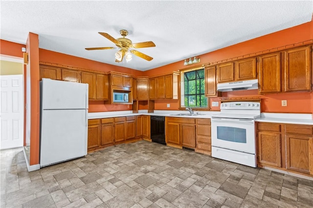 kitchen featuring white appliances, under cabinet range hood, a sink, brown cabinets, and light countertops