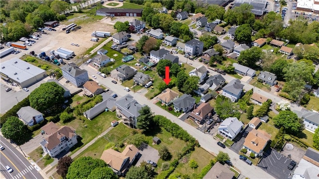 aerial view of property and surrounding area featuring nearby suburban area