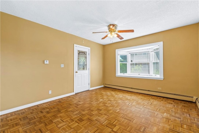 empty room with baseboard heating, baseboards, ceiling fan, and a textured ceiling