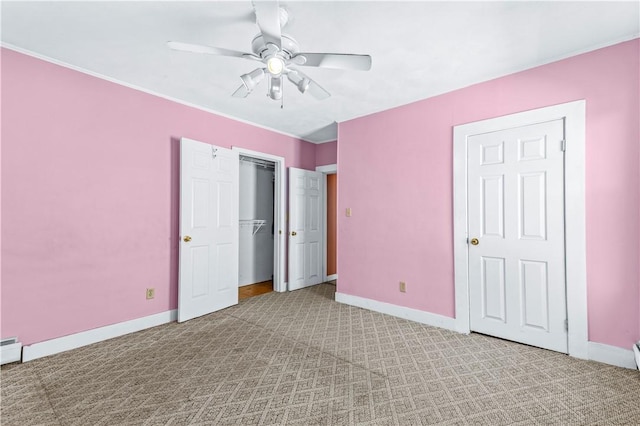 unfurnished bedroom with baseboards, light carpet, ceiling fan, and crown molding