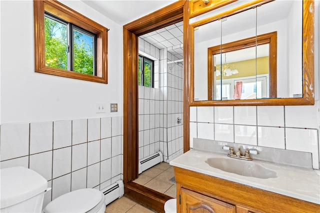 bathroom featuring tile walls, a baseboard heating unit, toilet, tile patterned floors, and vanity