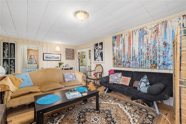 living area with wood finished floors and crown molding