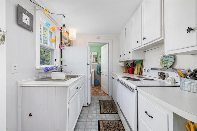 kitchen with white appliances, light countertops, white cabinetry, light flooring, and under cabinet range hood