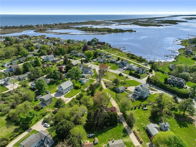aerial view of property and surrounding area with a nearby body of water and nearby suburban area