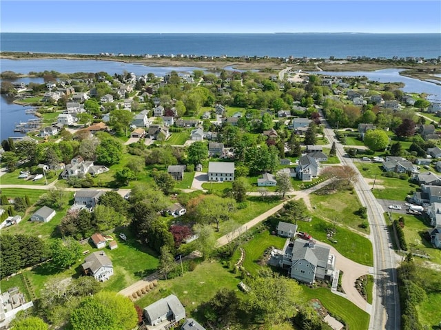 aerial view of property and surrounding area with a nearby body of water and nearby suburban area