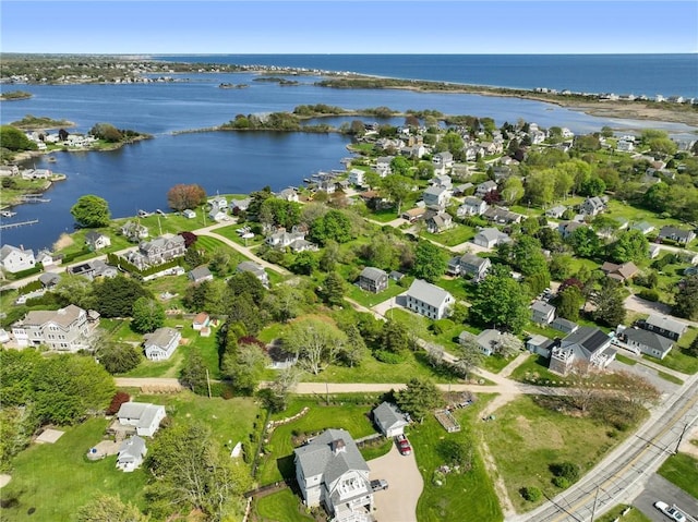 view of property location with a nearby body of water and nearby suburban area