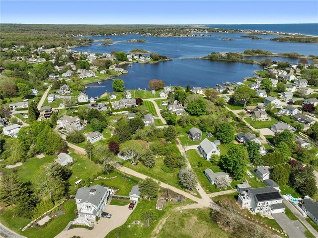 aerial overview of property's location with a nearby body of water and nearby suburban area