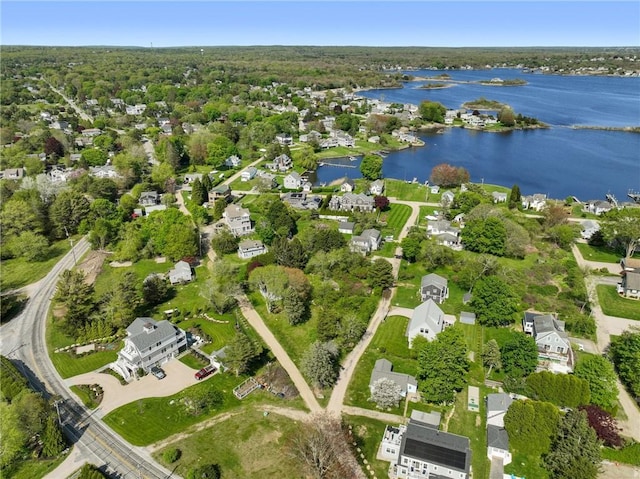 aerial view of property's location with a large body of water and nearby suburban area