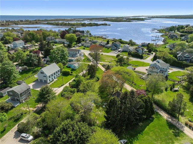 aerial view of residential area featuring a large body of water