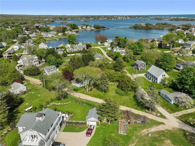 aerial view of property and surrounding area featuring a nearby body of water and nearby suburban area