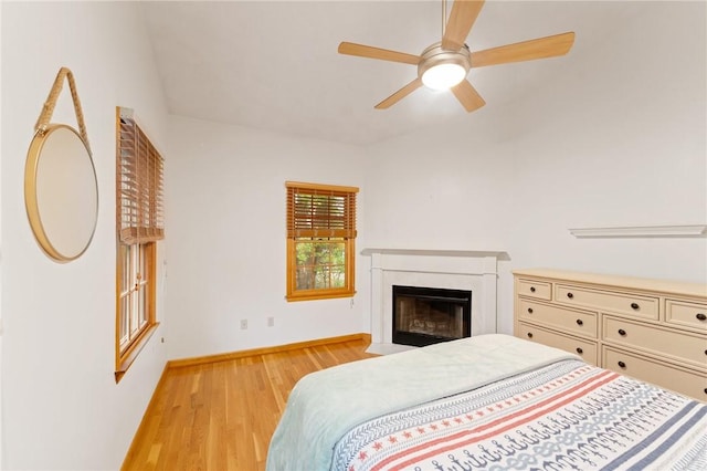6 Windward Cir, Narragansett, RI 02882 - bedroom with light wood-type flooring, baseboards, a fireplace with flush hearth, and a ceiling fan