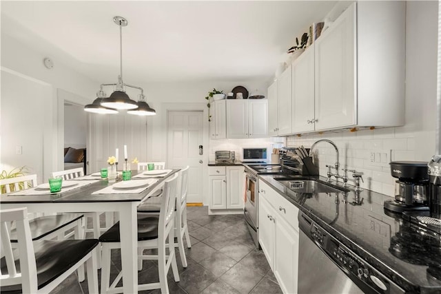 33 Marsh St Unit 1, Newport, RI 02840 - kitchen featuring stainless steel appliances, a sink, tasteful backsplash, white cabinetry, and dark stone counters
