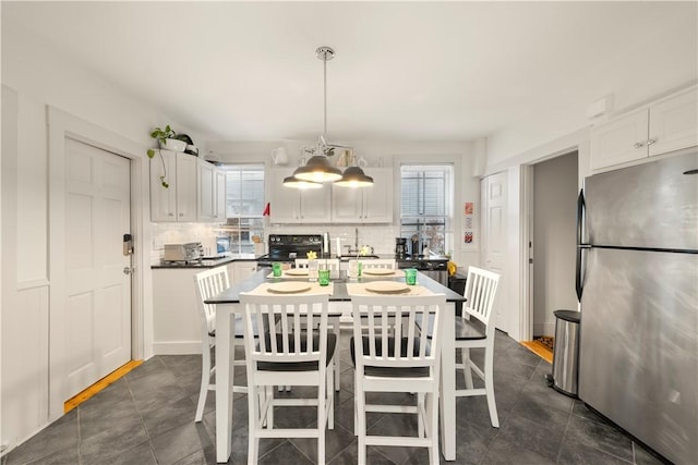 33 Marsh St Unit 1, Newport, RI 02840 - dining space with healthy amount of natural light and dark tile patterned floors