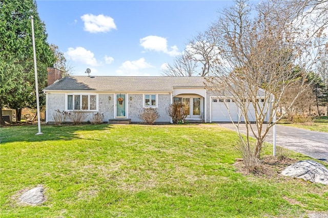 single story home featuring driveway, a chimney, an attached garage, a front lawn, and entry steps