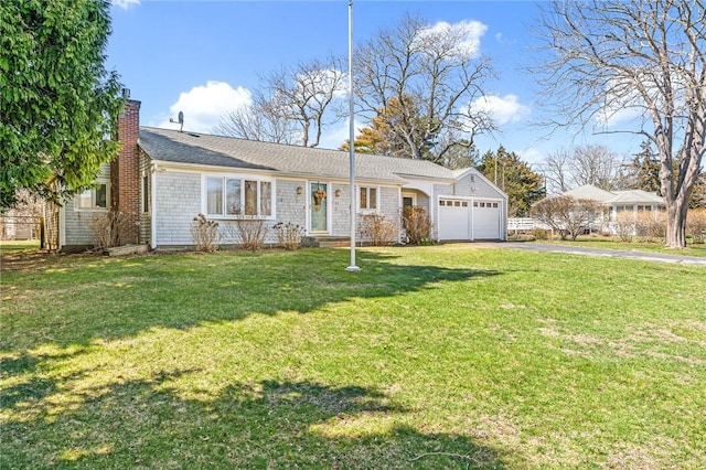 view of front of property featuring driveway, a chimney, a garage, and a front lawn