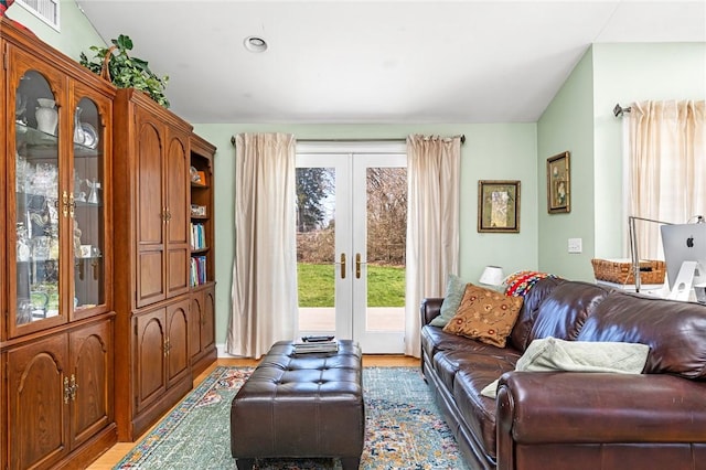 living area featuring french doors and light wood finished floors