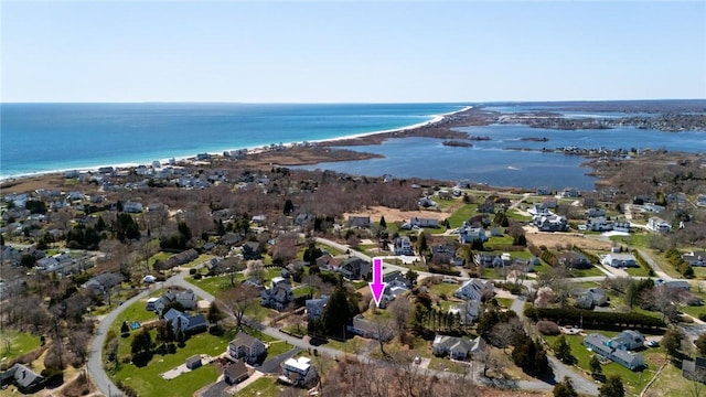 aerial view of property and surrounding area with a nearby body of water and nearby suburban area