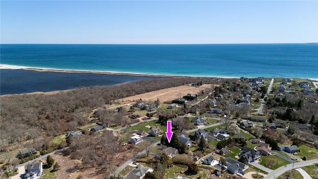 view of property location featuring unending shoreline and nearby suburban area
