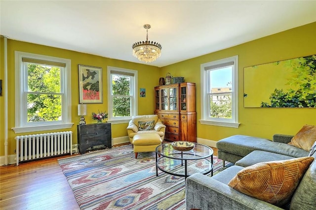 living area featuring radiator heating unit, healthy amount of natural light, and baseboards