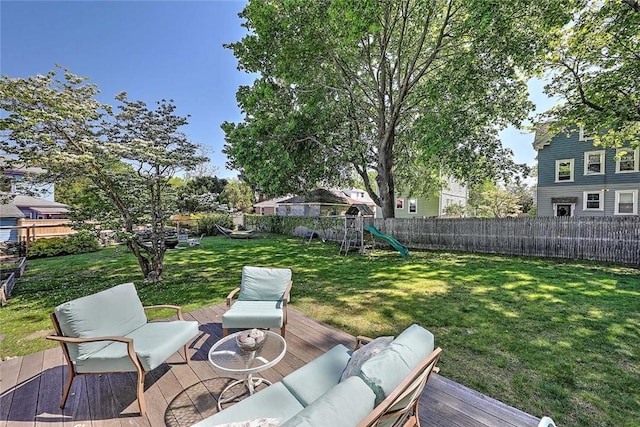 view of yard featuring outdoor lounge area, a playground, and a wooden deck