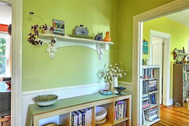 mudroom with wainscoting and wood finished floors