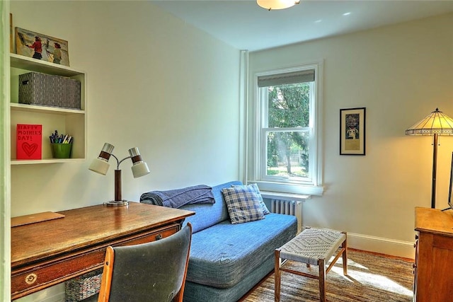 office space featuring baseboards and radiator heating unit