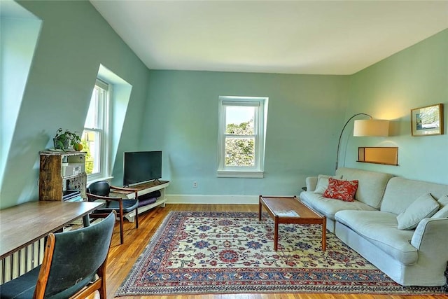 living room featuring wood finished floors and baseboards