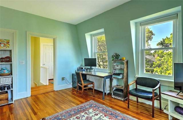 office area with wood finished floors and baseboards