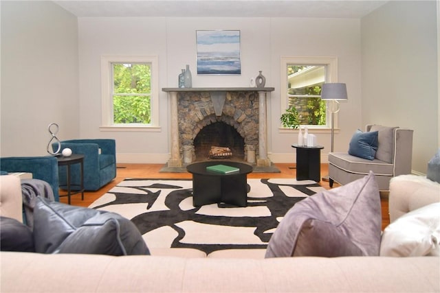 244 Kingstown Rd, Narragansett, RI 02882 - living area featuring wood finished floors, baseboards, and a stone fireplace