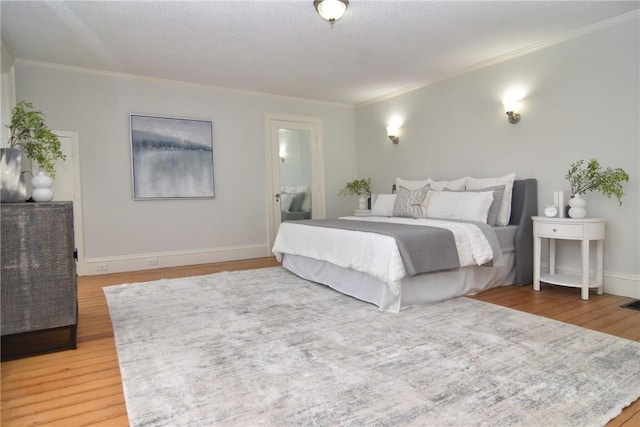 244 Kingstown Rd, Narragansett, RI 02882 - bedroom with crown molding, light wood-type flooring, baseboards, and ensuite bathroom