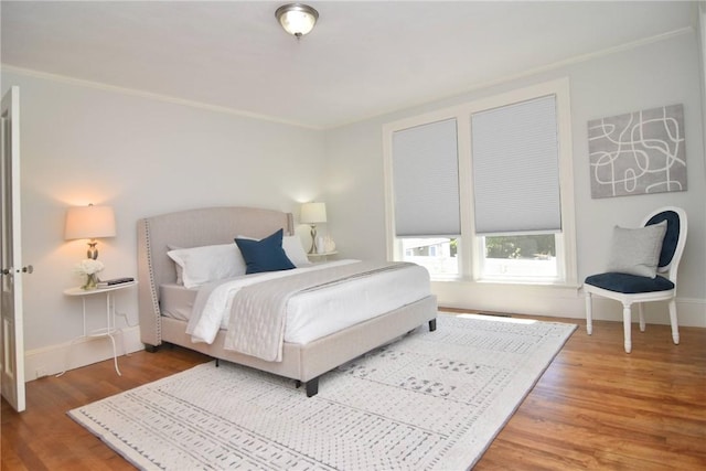 244 Kingstown Rd, Narragansett, RI 02882 - bedroom featuring wood finished floors, ornamental molding, and baseboards