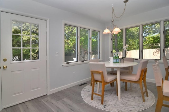 244 Kingstown Rd, Narragansett, RI 02882 - dining room with baseboards, a chandelier, and wood finished floors