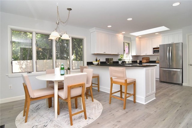 244 Kingstown Rd, Narragansett, RI 02882 - dining space with light wood-style floors, recessed lighting, and baseboards