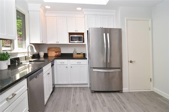 244 Kingstown Rd, Narragansett, RI 02882 - kitchen with stainless steel appliances, a sink, light wood-style floors, white cabinetry, and baseboards