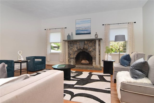 244 Kingstown Rd, Narragansett, RI 02882 - living room with wood finished floors and a stone fireplace