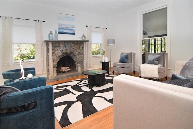 244 Kingstown Rd, Narragansett, RI 02882 - living room with wood finished floors and a stone fireplace