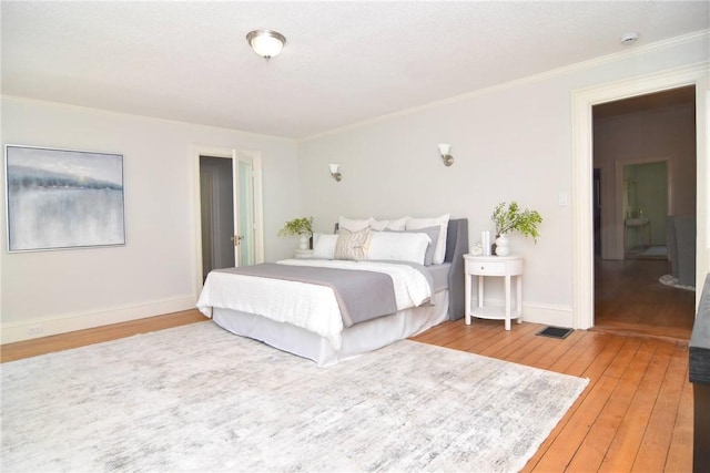 244 Kingstown Rd, Narragansett, RI 02882 - bedroom with light wood-style flooring, crown molding, and baseboards
