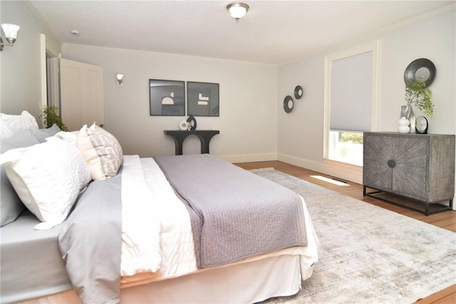 244 Kingstown Rd, Narragansett, RI 02882 - bedroom featuring wood finished floors, ornamental molding, and baseboards