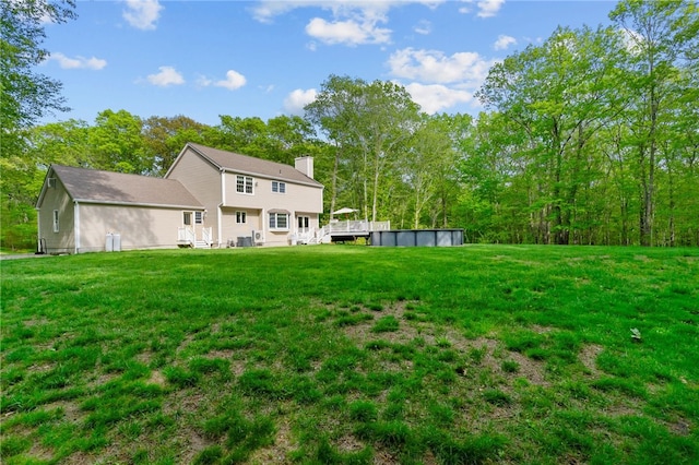 195 Deer Ridge Dr, North Kingstown, RI 02874 - view of green lawn with an outdoor pool and a deck